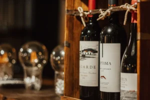 A set of elegant wine bottles displayed in a wooden rack.